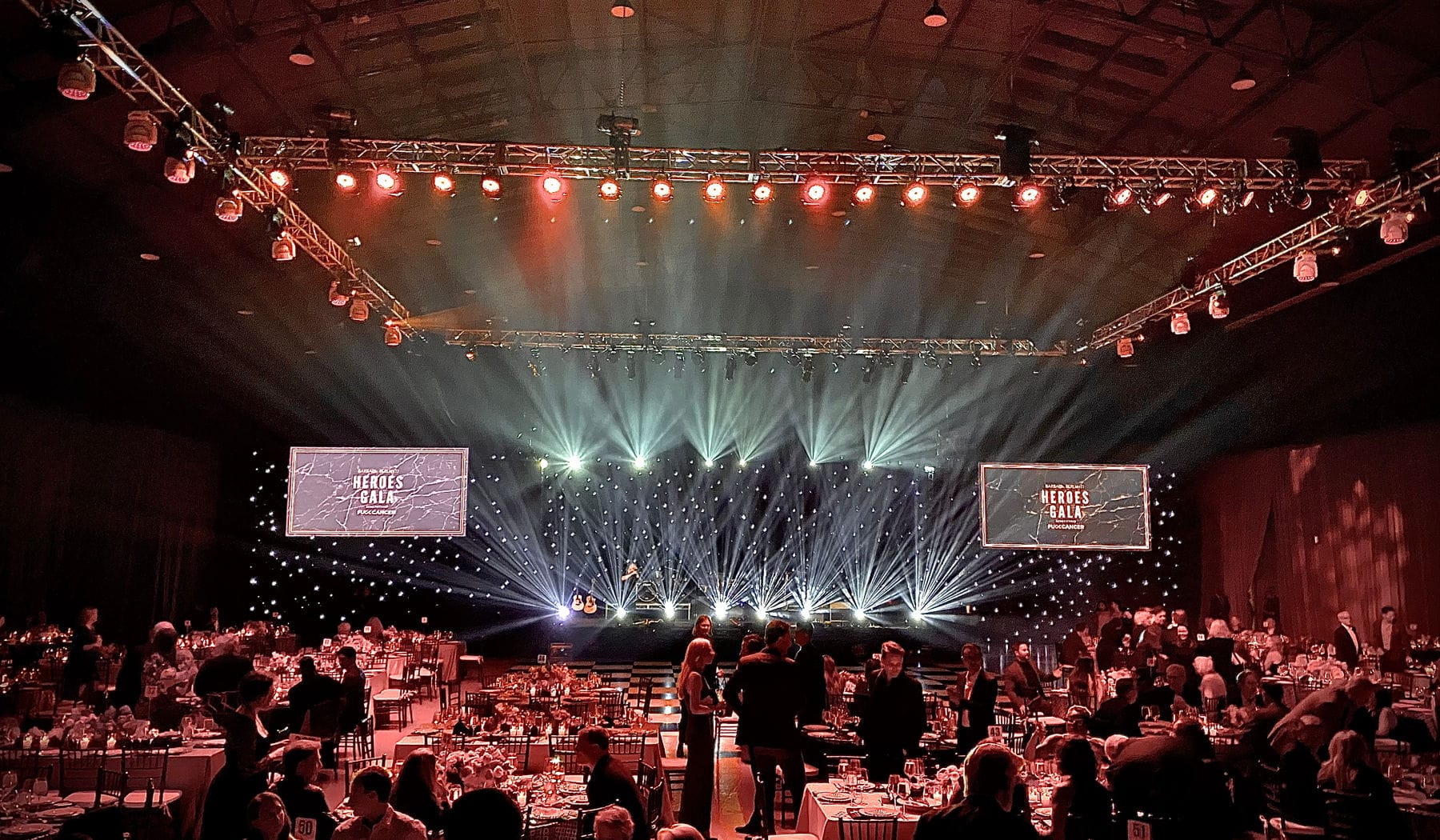 A full house under a lighting rig at a 94 Audio & Lighting show