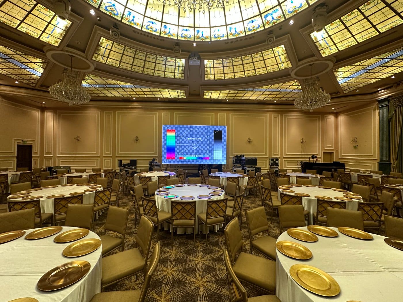 A domed ballroom set with an LED wall for a film premiere